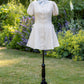 Toasted Crème Custard Dress | Short Sleeve Muslin Mini Dress With Adjustable Side Ties And Wooden Bead Accents