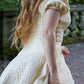 Toasted Crème Custard Dress | Short Sleeve Muslin Mini Dress With Adjustable Side Ties And Wooden Bead Accents
